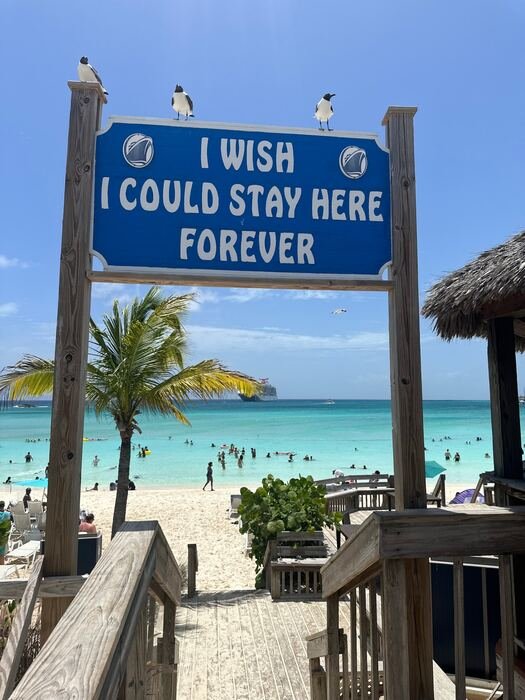 I Wish I Could Stay Here Forever sign overlooking the beach